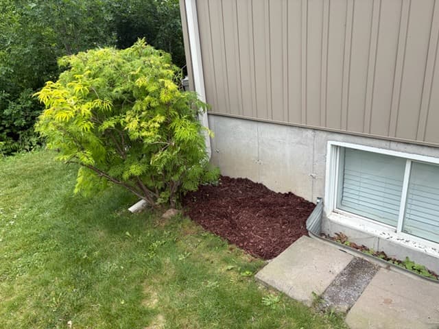 Residential foundation area prepared for drainage and downspout work